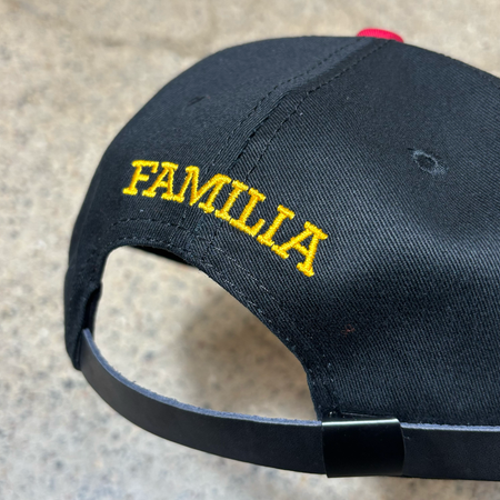 Close detail of familia embroidered font above closure. 