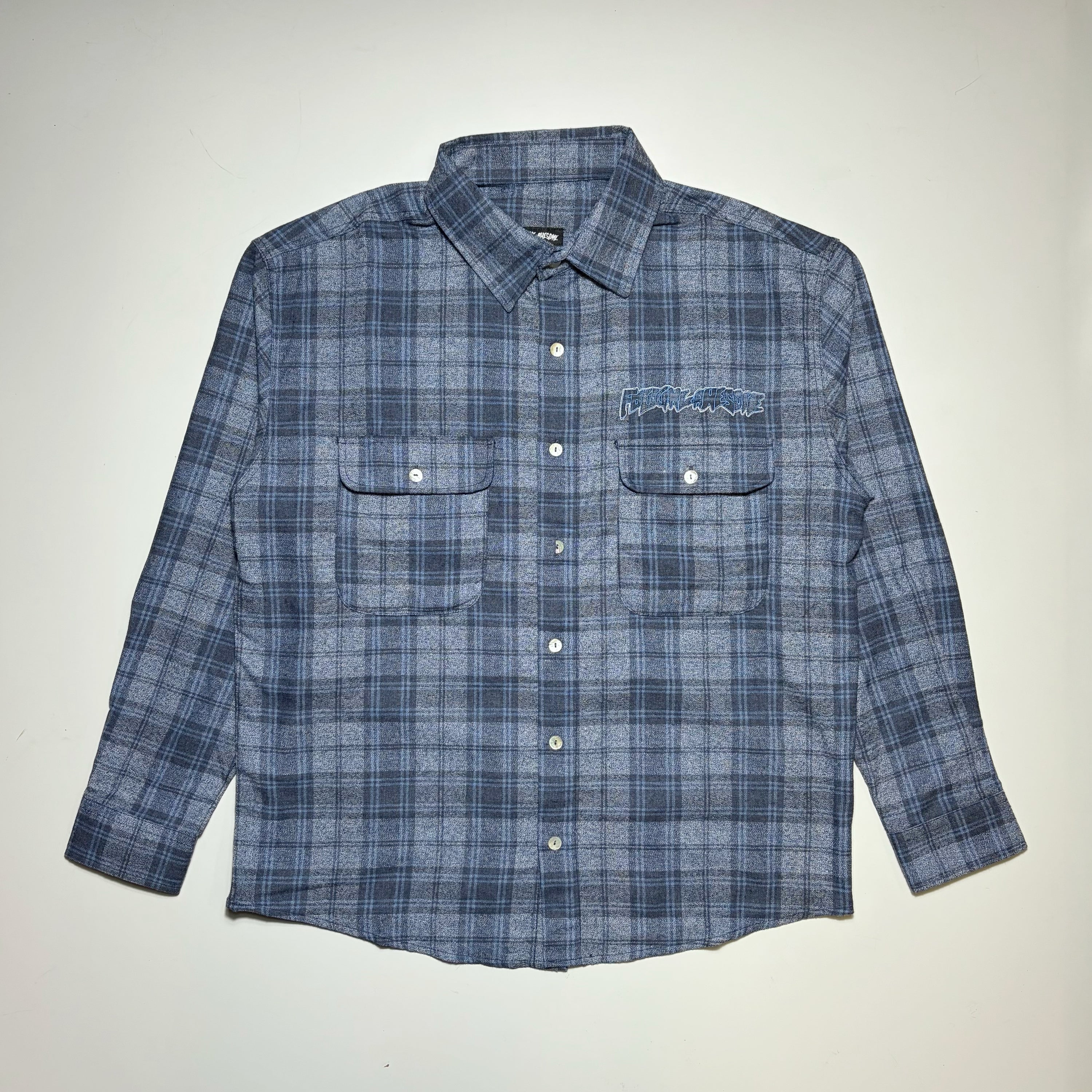 Full image of Fucking Awesome Bruce Flannel in navy/blue woven plaid. With Fucking Awesome embroidered patch on chest.