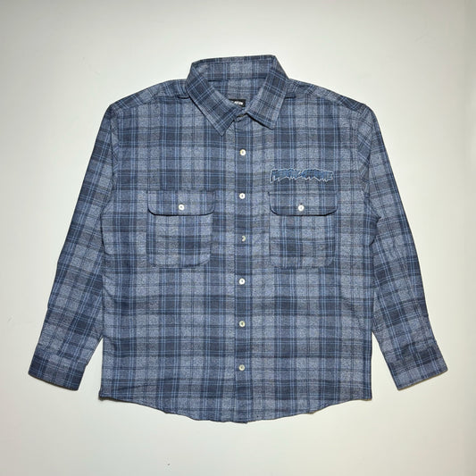 Full image of Fucking Awesome Bruce Flannel in navy/blue woven plaid. With Fucking Awesome embroidered patch on chest.
