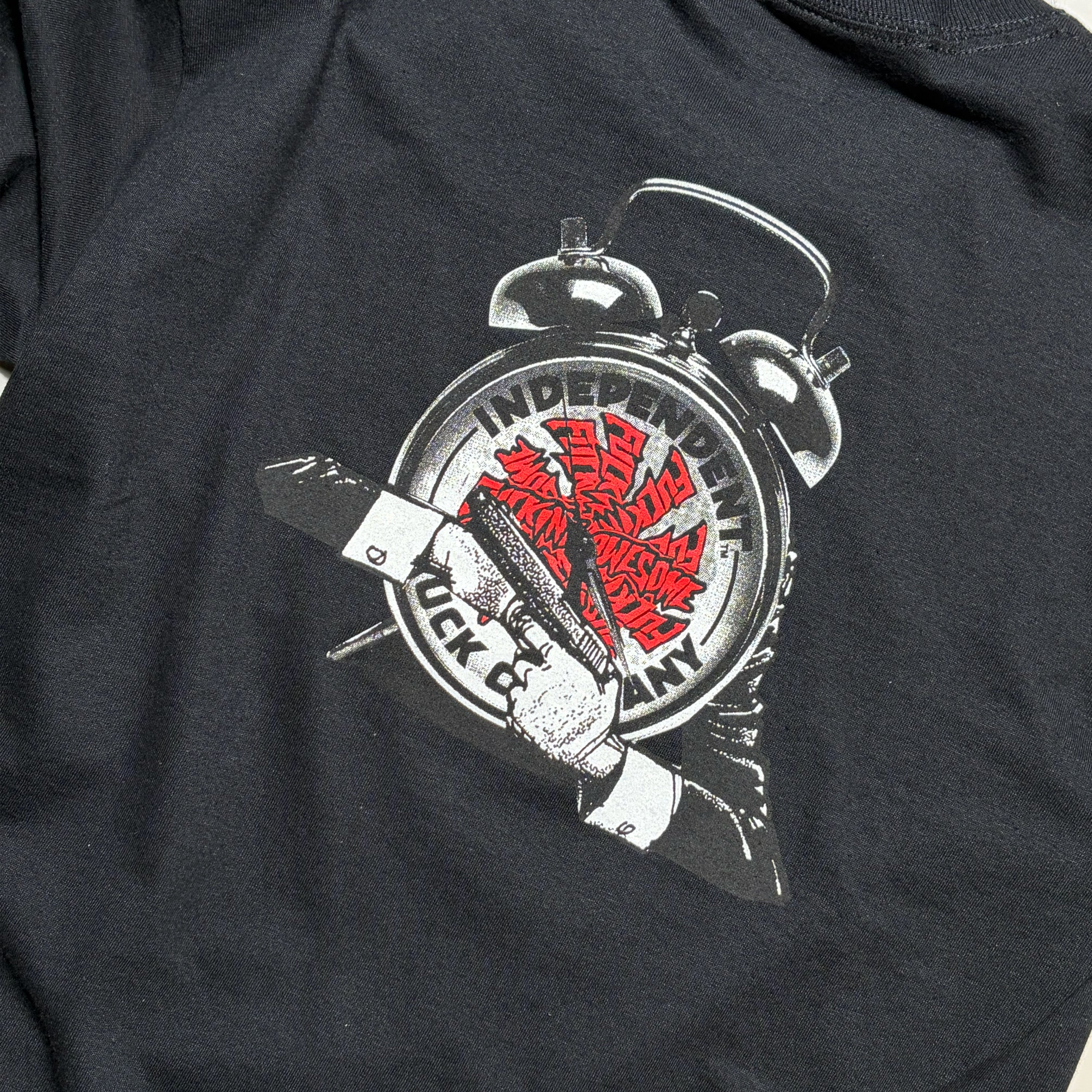Close-up of a printed graphic print of a silver alarm clock with fucking awesome text on the face, and the words 'INDEPENDENT TRUCK COMPANY' printed on it.