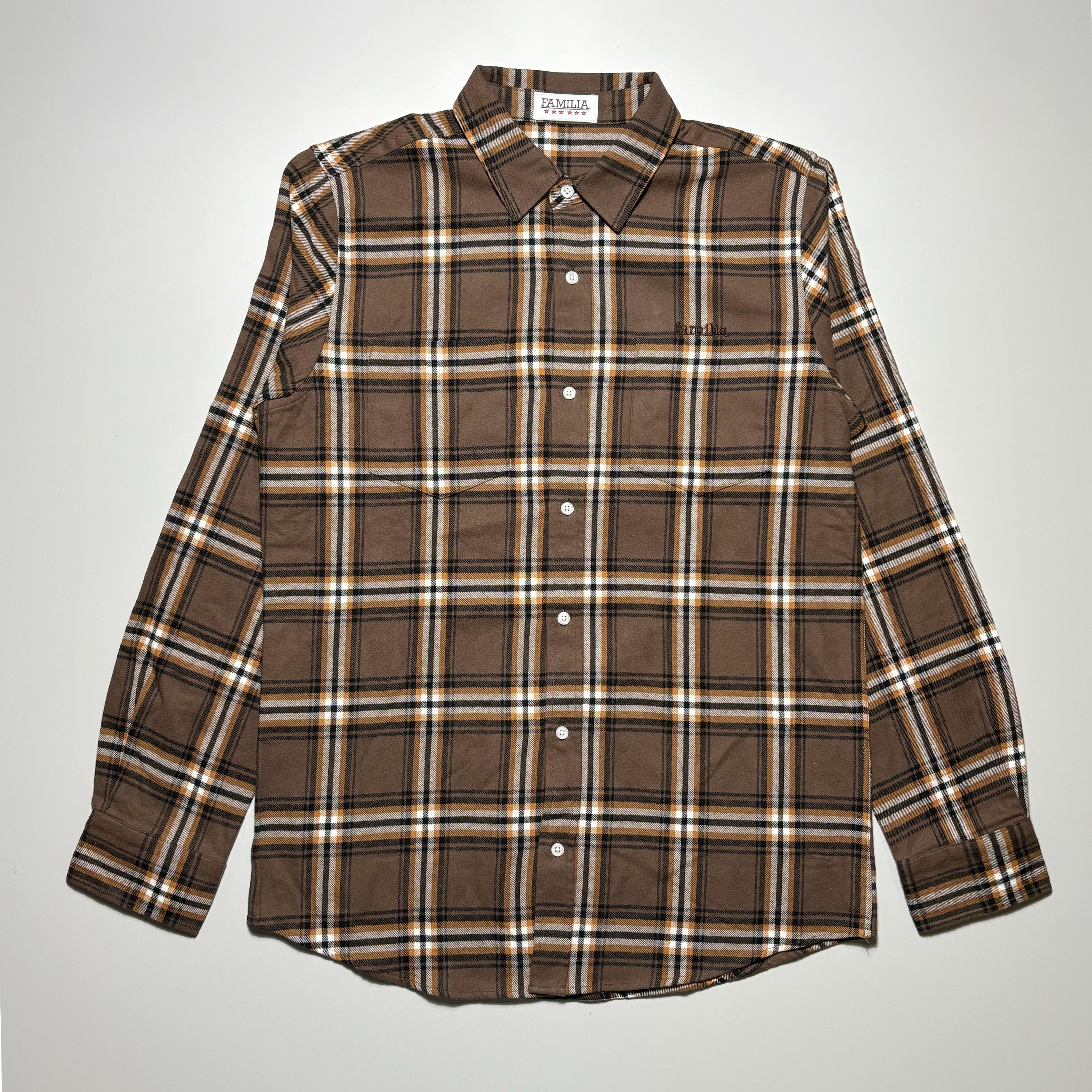 Front image of brown/tan woven flannel with double chest pockets and white buttons. 