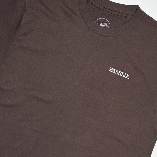 Close up detail of dark brown t-shirt with 'FAMILIA' embroidered logo in white on chest.