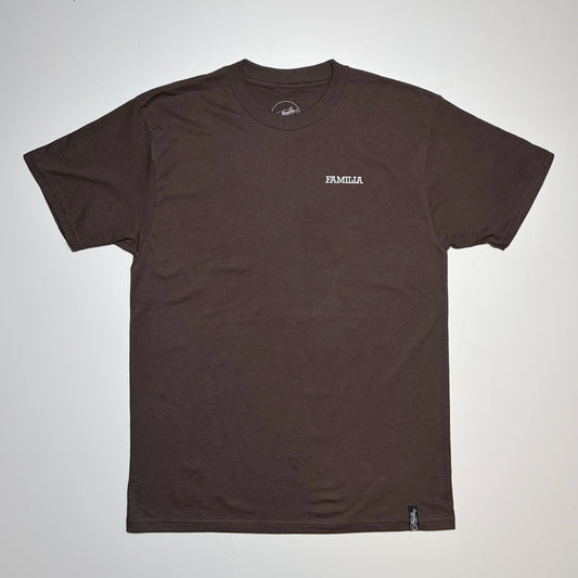 A dark brown short-sleeve t-shirt with a small white 'FAMILIA' logo embroidered on the left chest, laid flat against a light gray background.