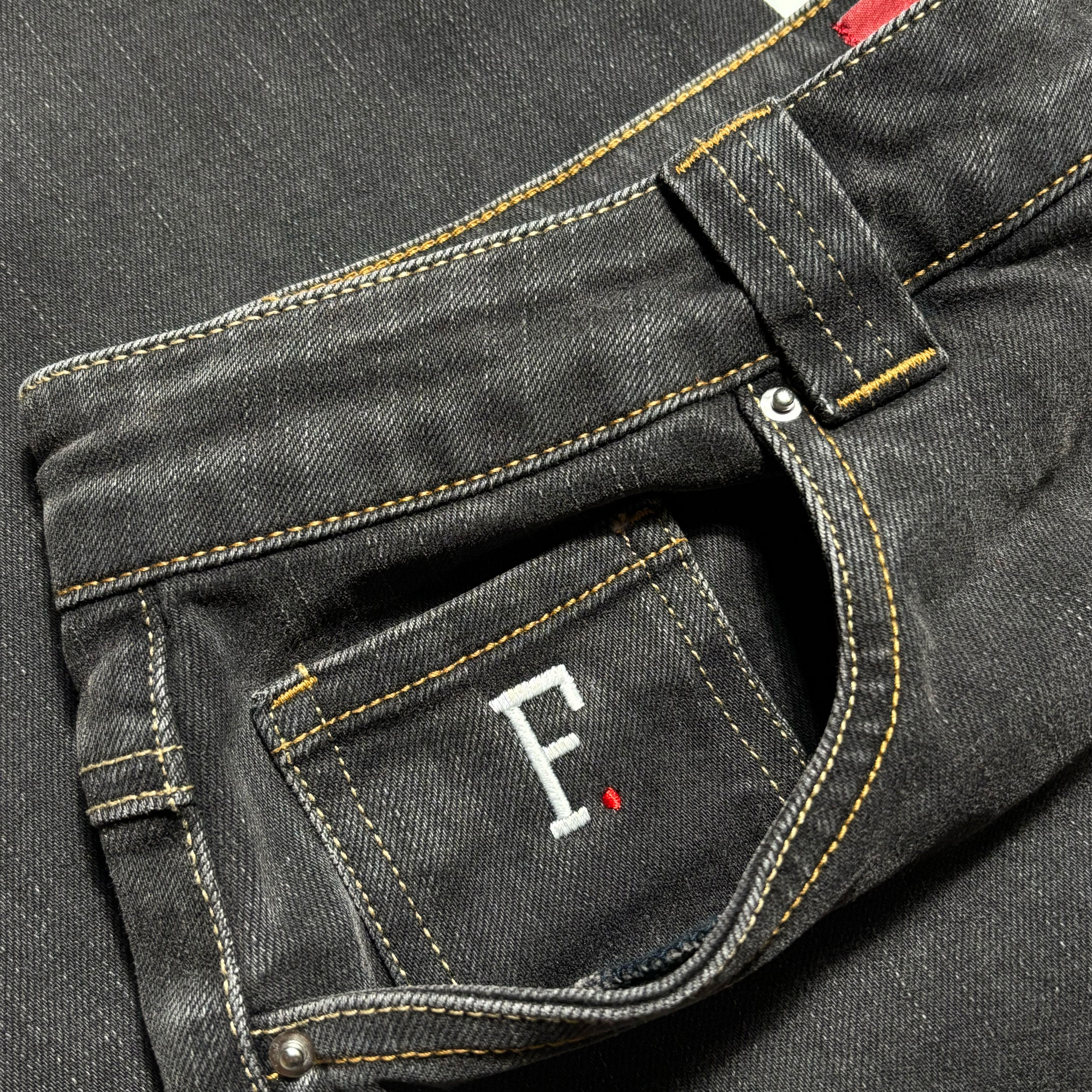 Close detail of F logo embroidered coin pocket and wash detail.