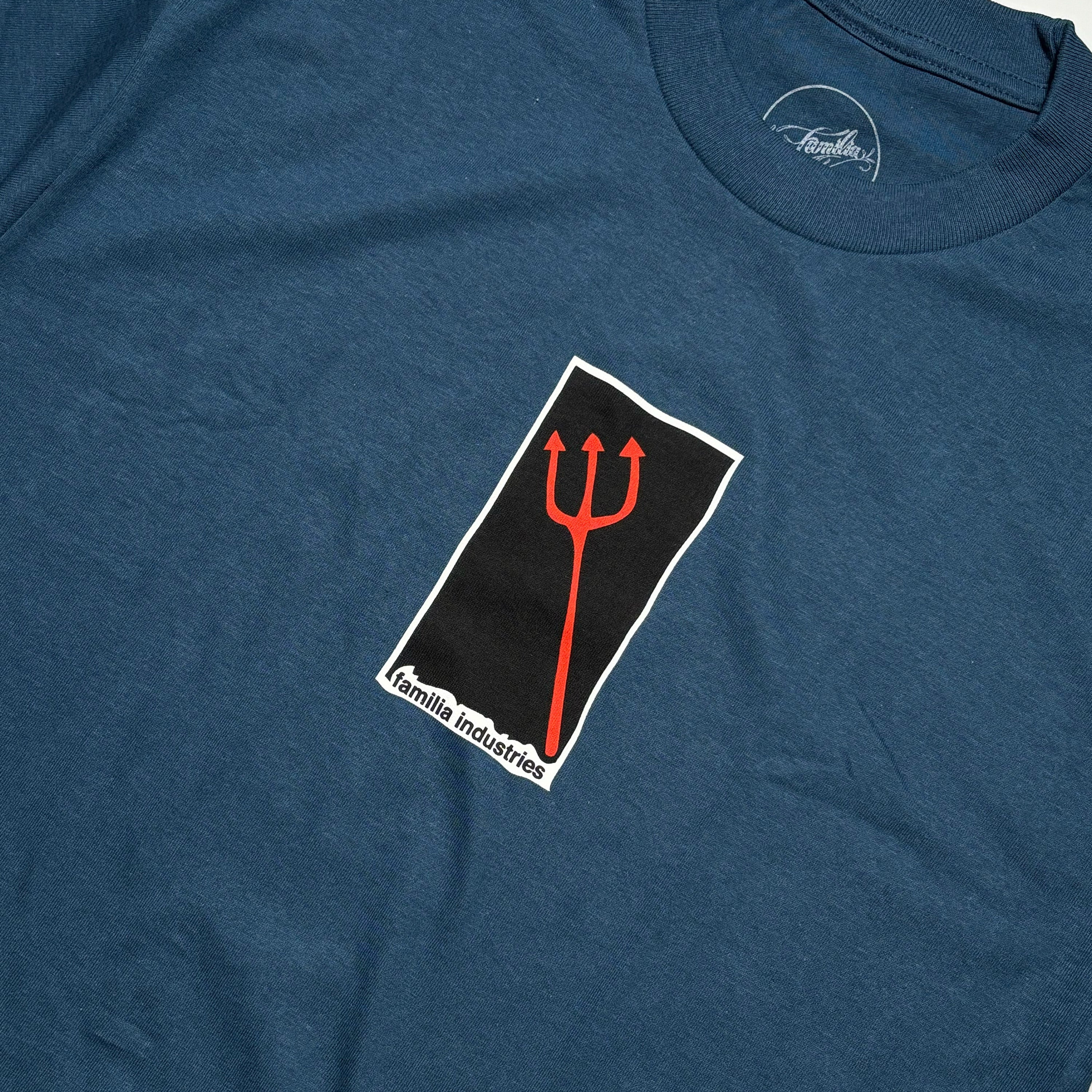 Close detail of pitchfork art centered on chest.