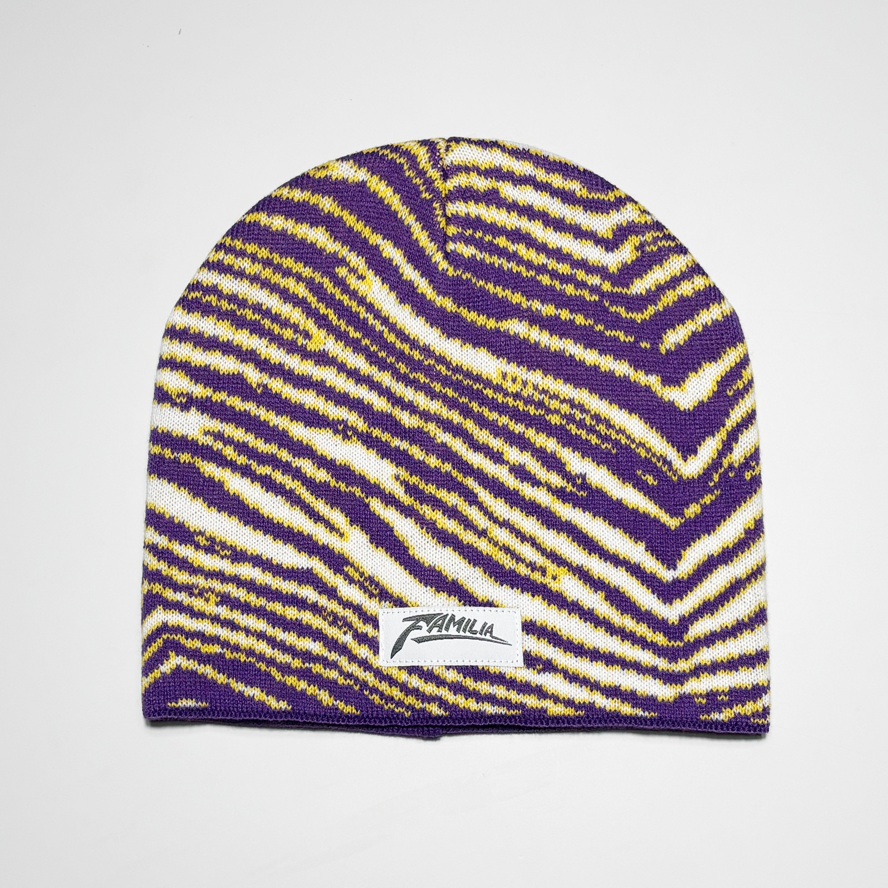 Purple and yellow striped beanie with woven label.