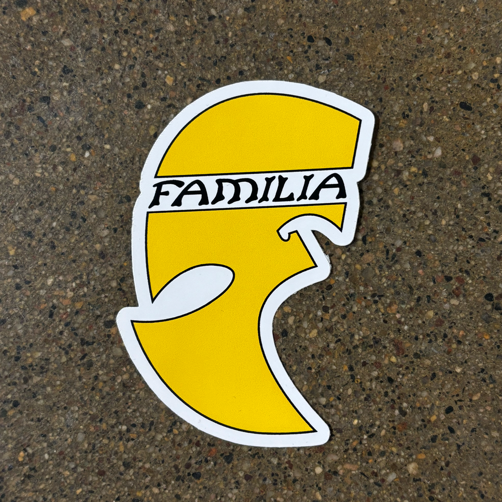 Full image of yellow sticker with familia font across the top. 