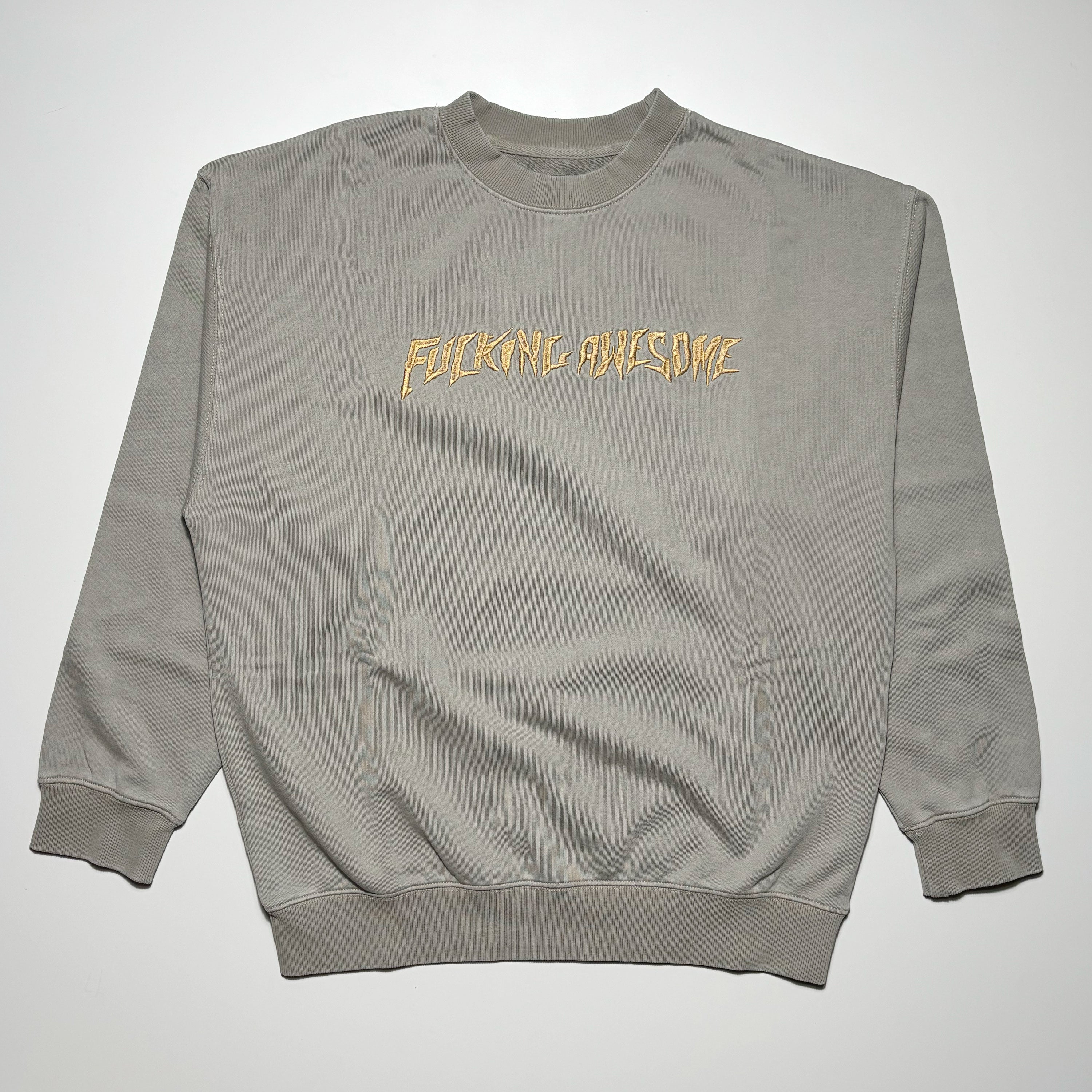 Front image of grey crewneck with embroidery on chest.
