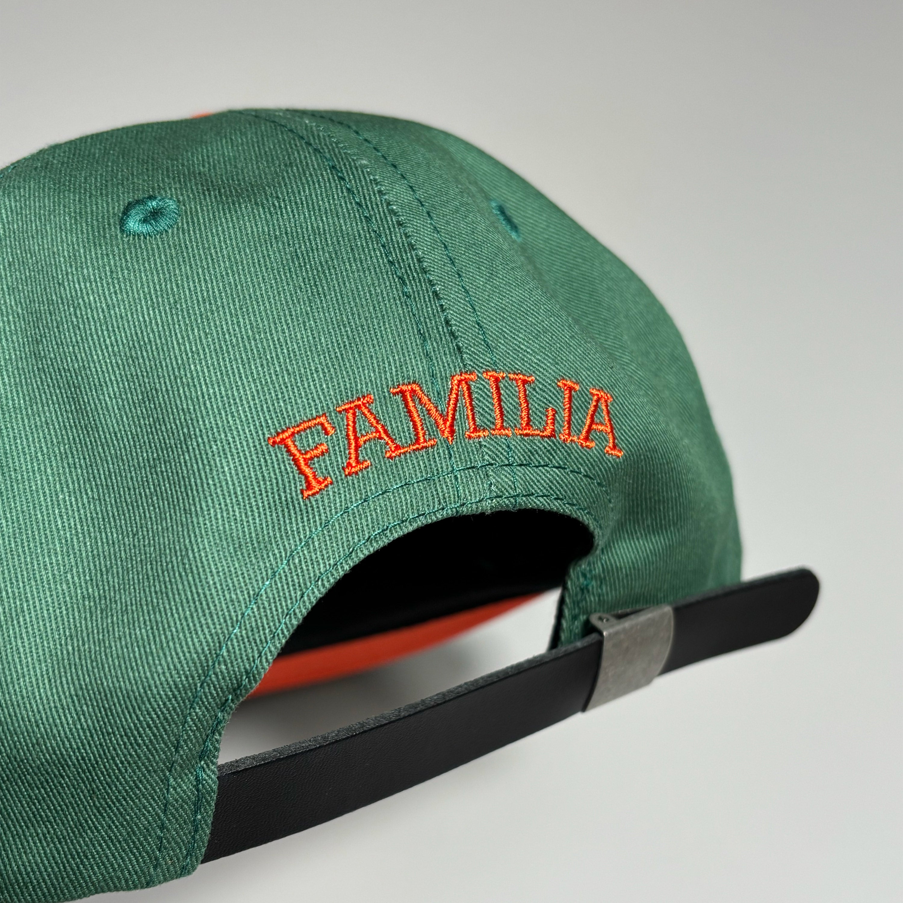 Familia embroidered font over back. 