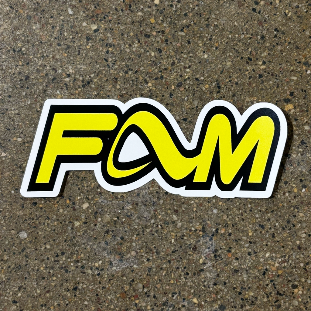 Full image of yellow and black sticker, saying FAM with the adio footwear A