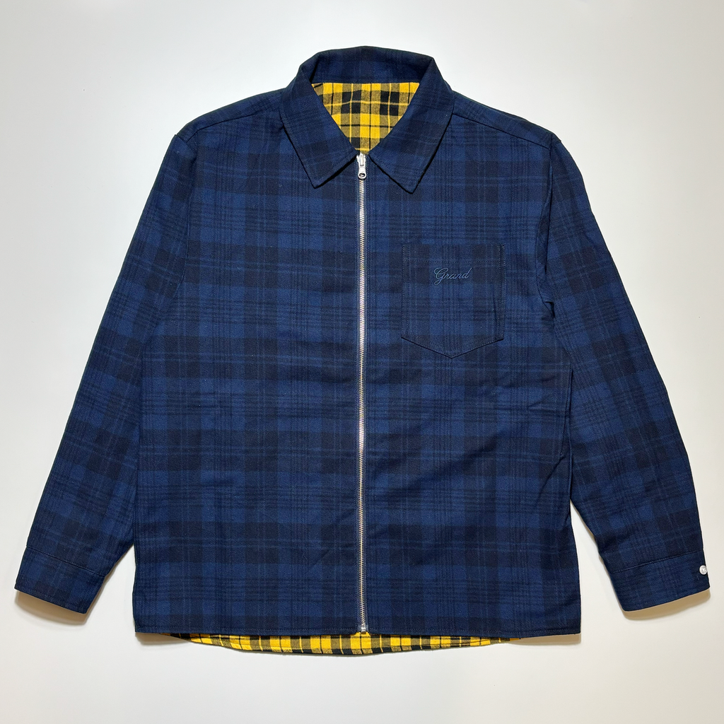 Front image of navy plaid zippered shirt with tonal embroidered script on pocket. 