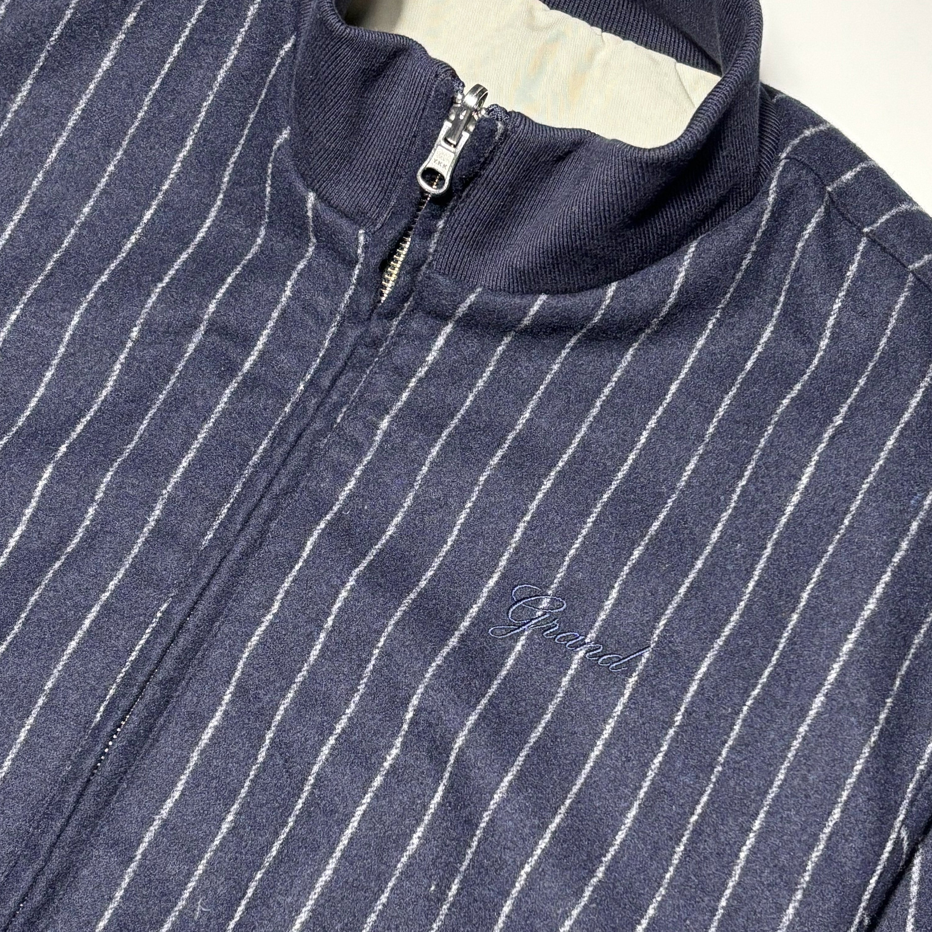 Close detail of pinstripes and embroidery.