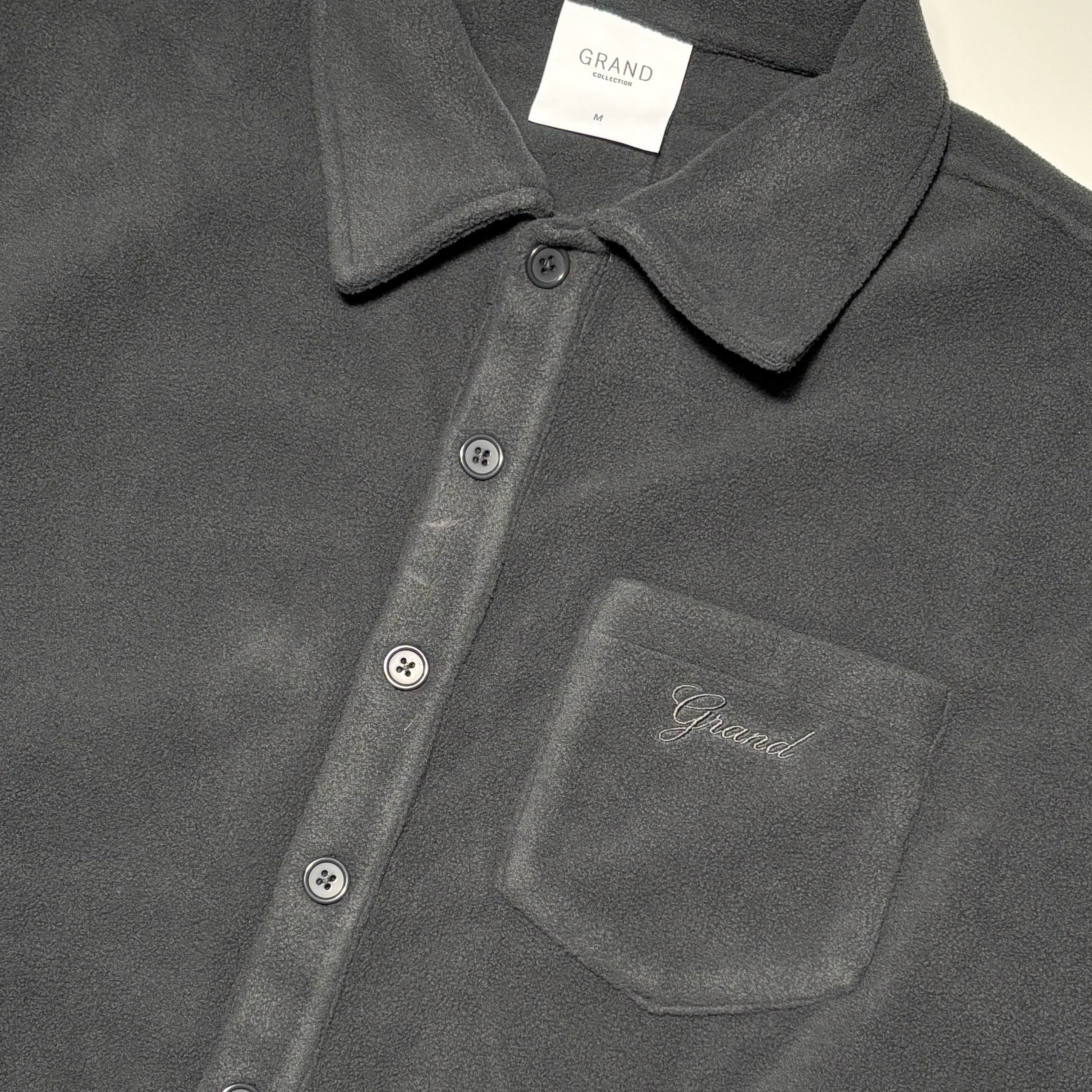 Close detail of embroidered chest pocket.