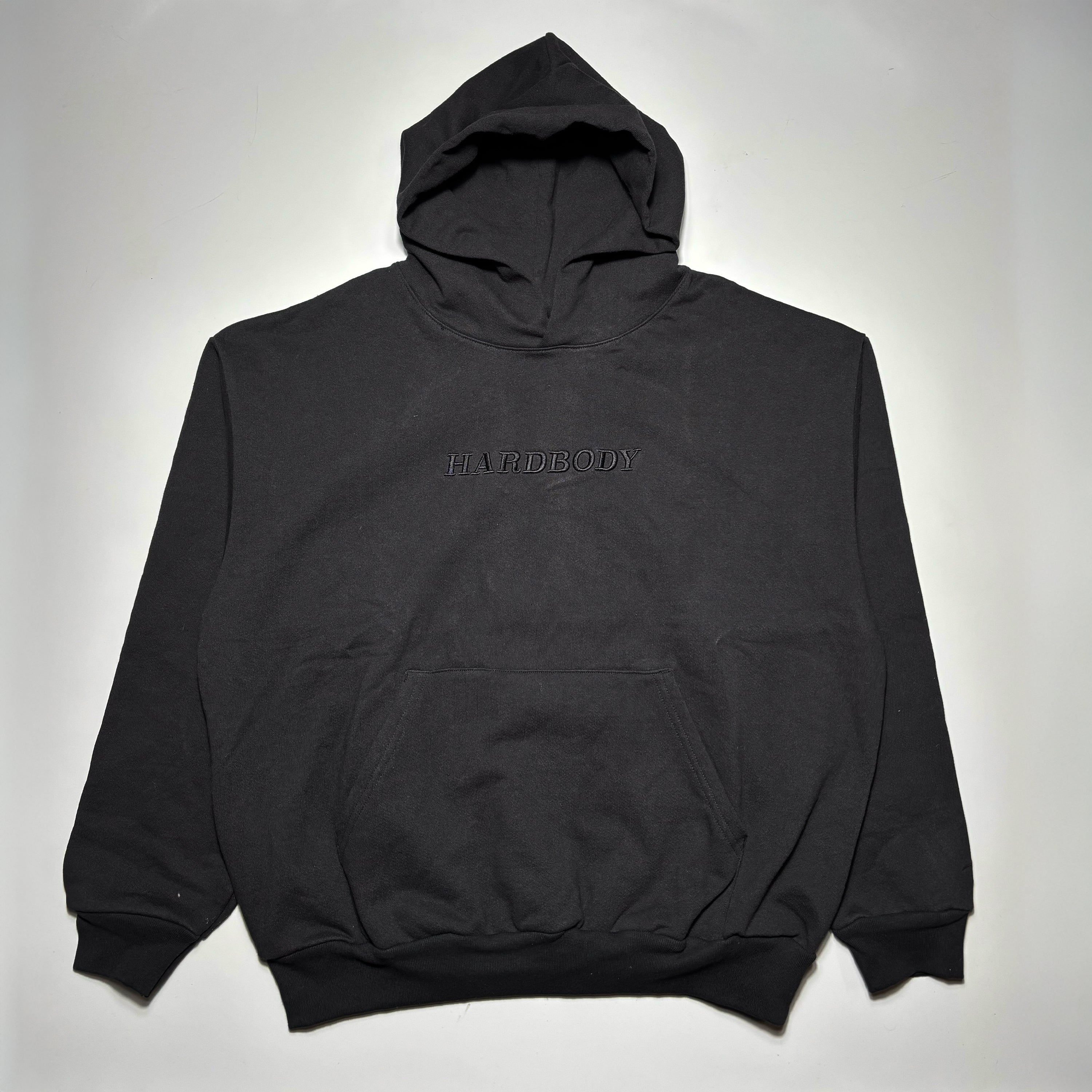 Full front image of black hoodie with black hardbody logo on chest.