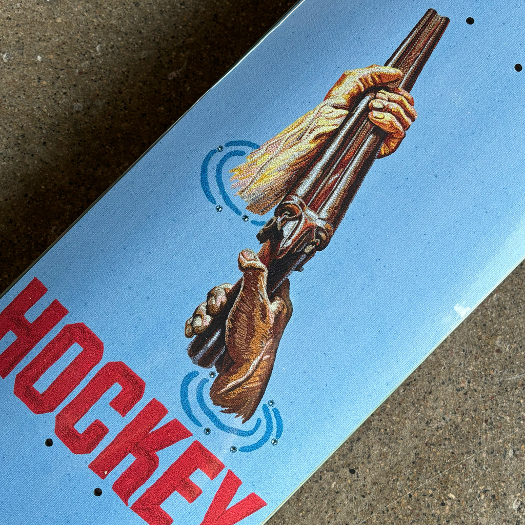 Close detail of shotgun artwork with hockey in red.