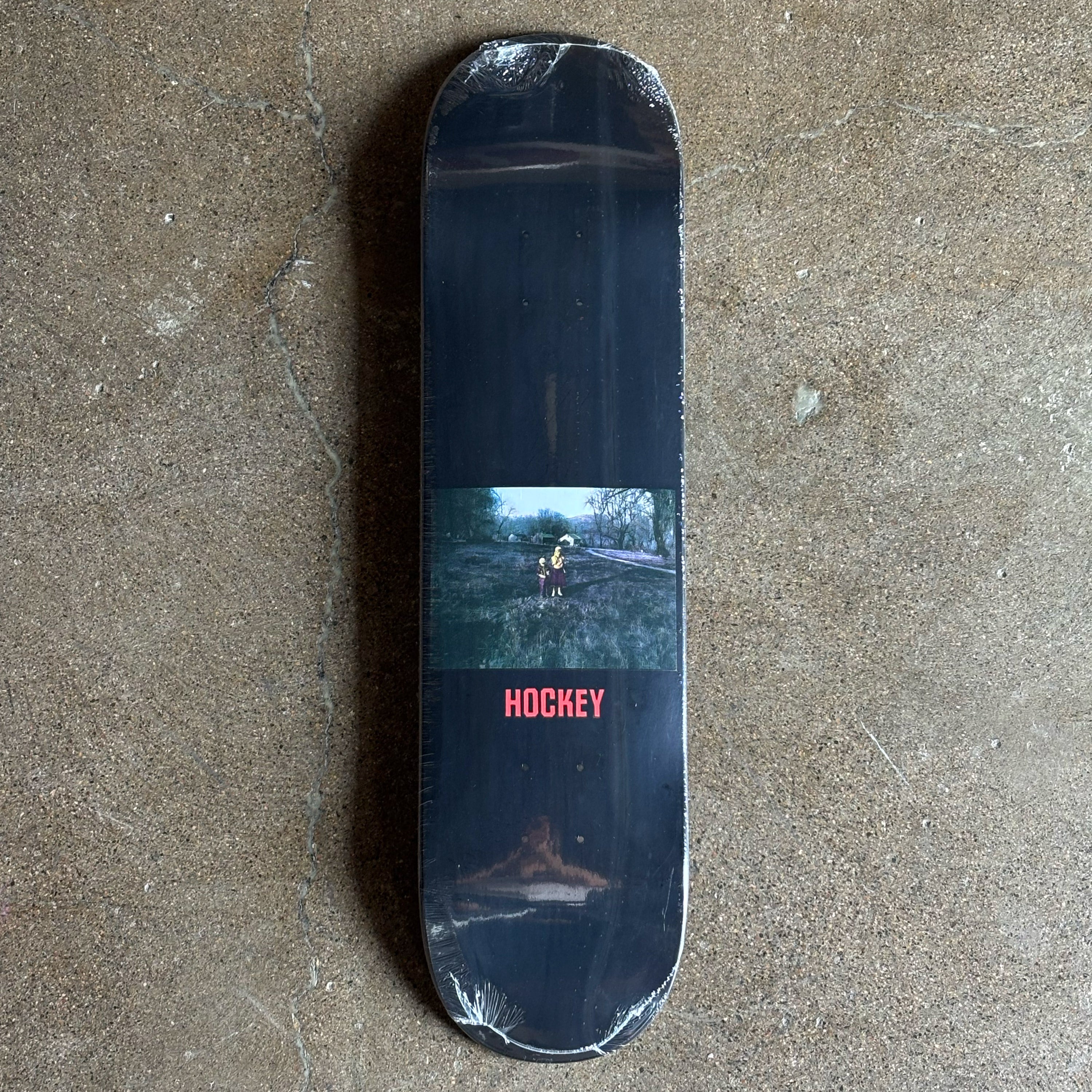 Skateboard deck with a printed design on a concrete surface