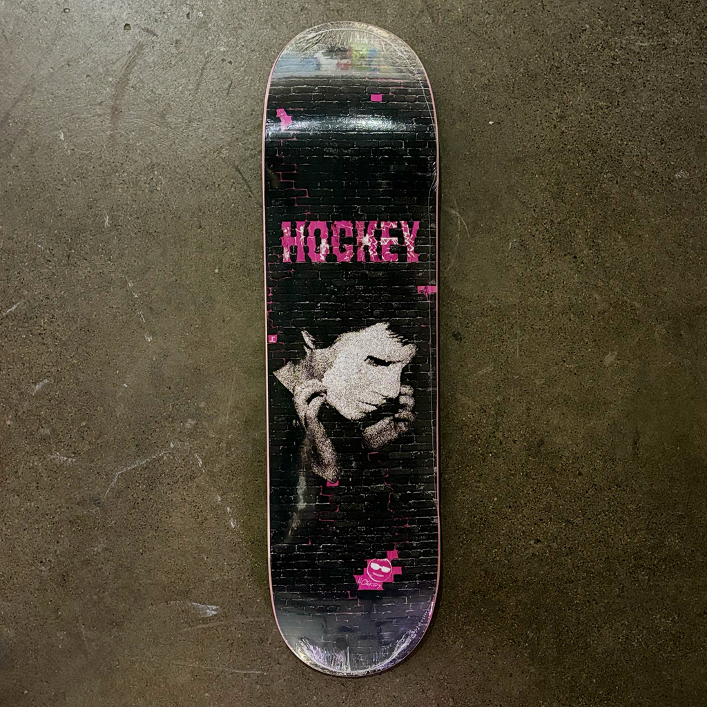 Full image of deck. Black brick texture with hockey font in pink and white mask overlay. 