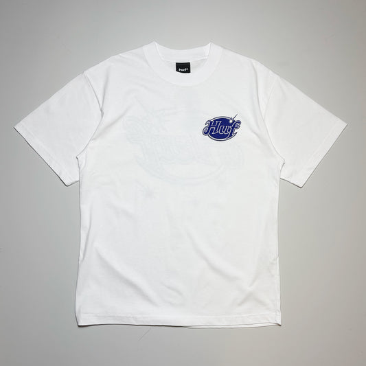 A white short-sleeve crewneck t-shirt with a blue and white 'HUF' logo graphic on the left chest, laid flat against a neutral gray background.