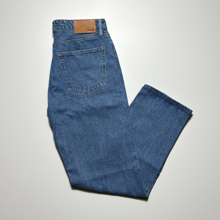 Image of blue indigo denim folded with leather HUF patch.