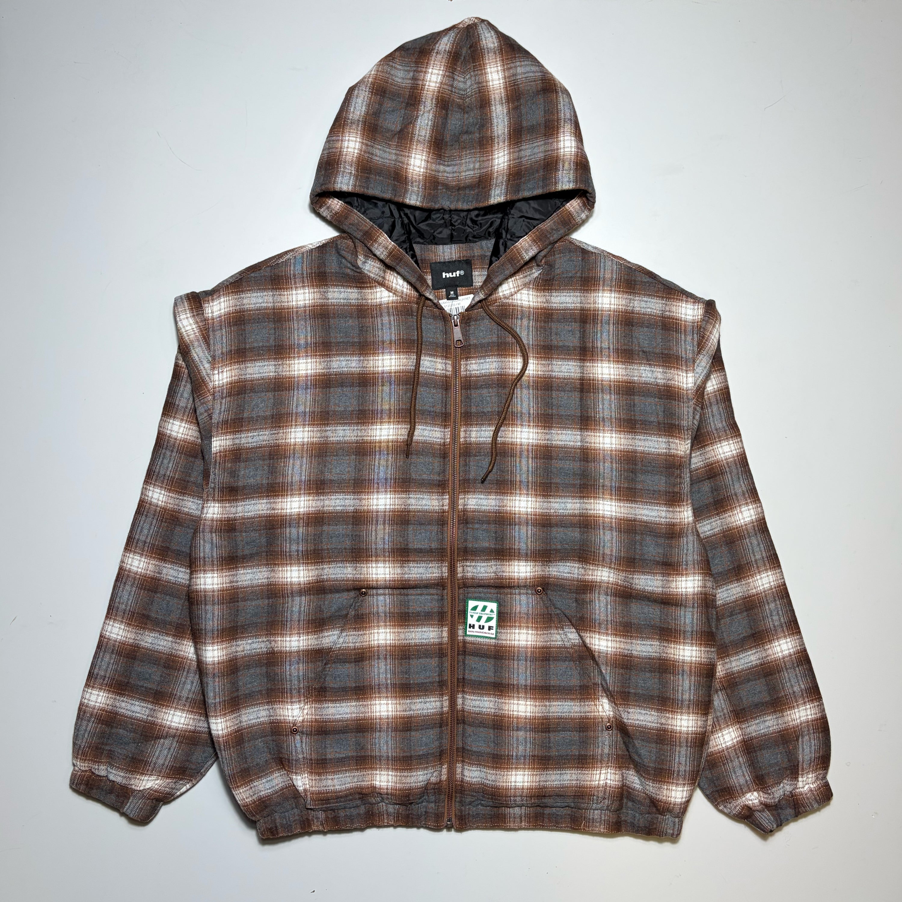 Full image, HUF plaid zippered quilted lined jacket. Woven label on pocket.