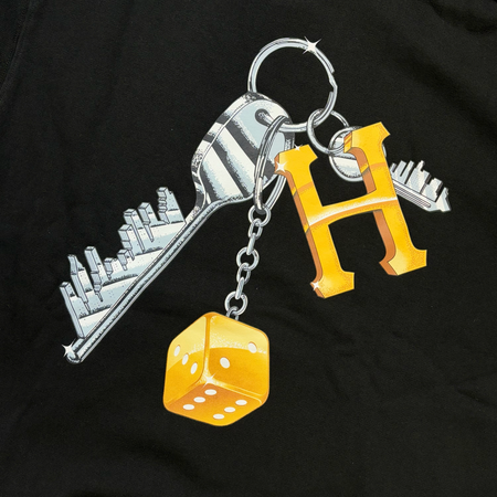 Close detail on keys with gold H and a dice printed on back