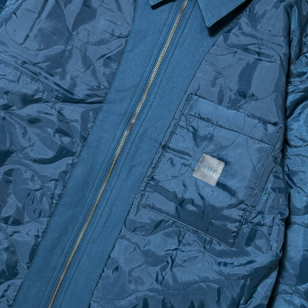 Close detail of quilted side. Chest pocket with silver huf woven label centered.