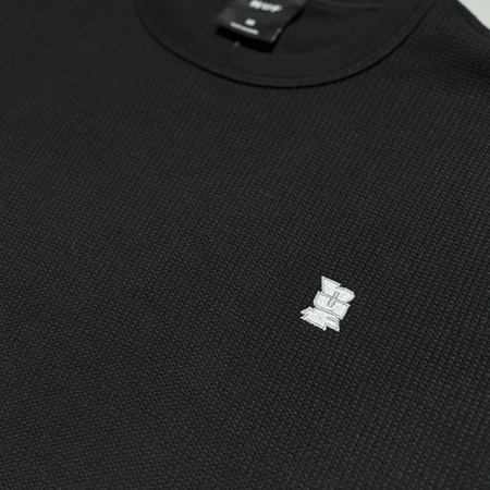 Close detail of HUF embroidered logo.