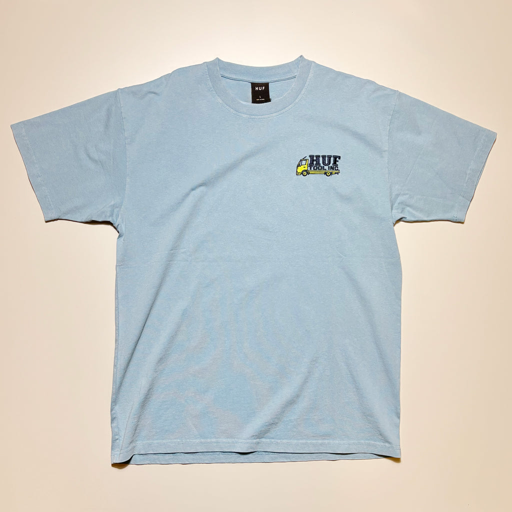 Front image of blue tee with embroidered art on chest.