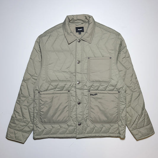 Full image, HUF zig-zag quilted chore jacket with custom button and embroidered logo on pocket. 