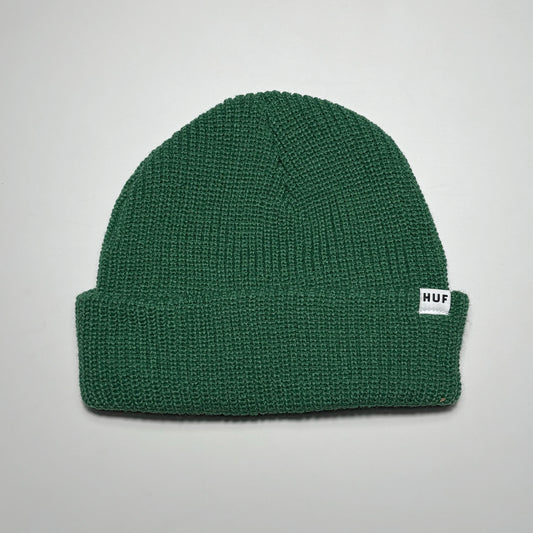 Green knit beanie with woven HUF label on fold.