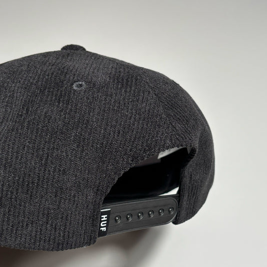 Back detail of black cord cap with HUF label on back.