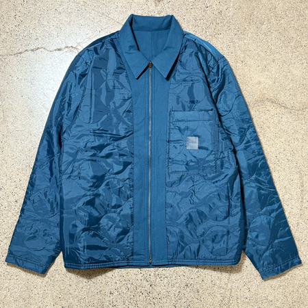 Full image of jacket. Quilted side with chest pocket and huf woven label