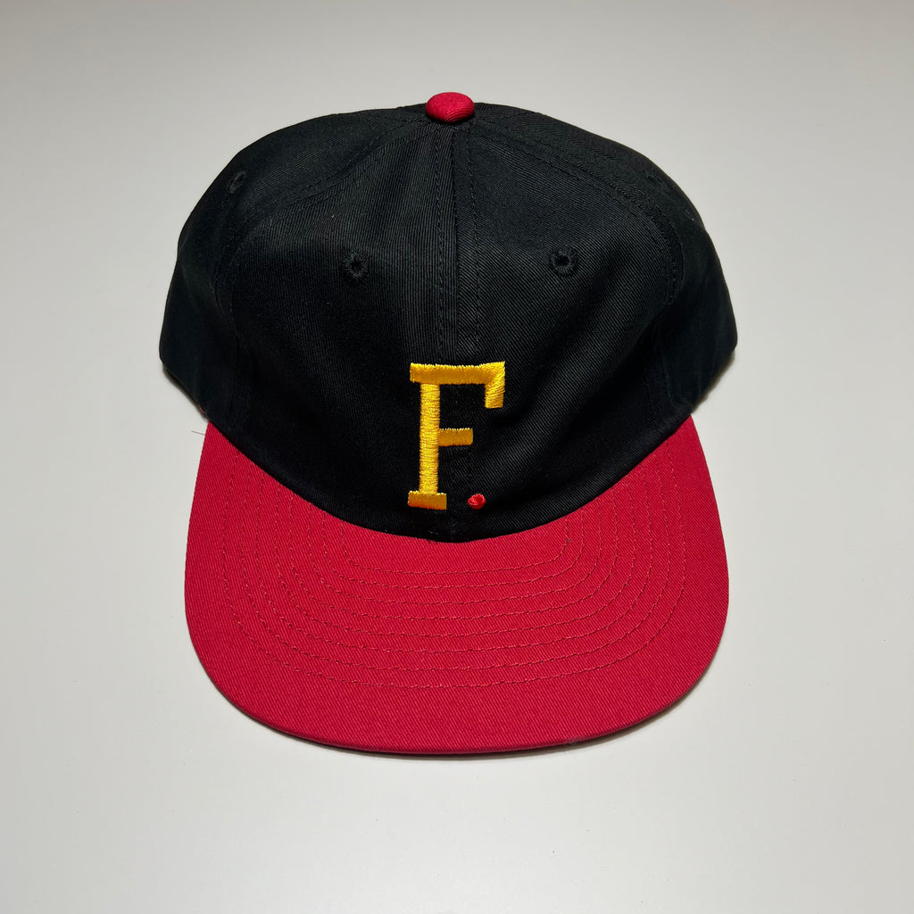 Unstructured 6 panel hat in black and red with yellow embroidered F. logo.