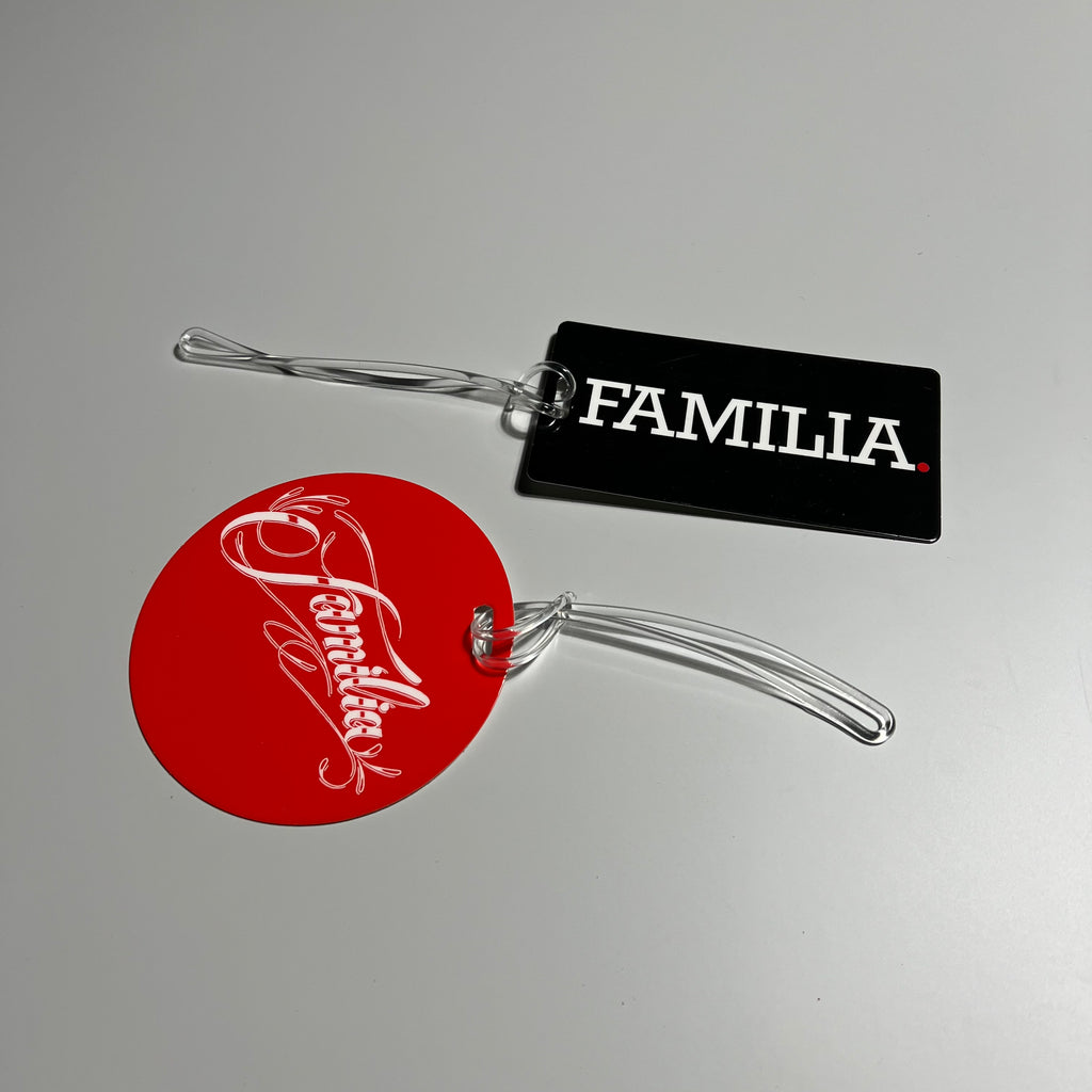 Top side of the familia red dot and black block luggage tags.