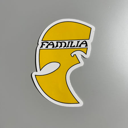 Full image of yellow sticker with familia font across the top. 