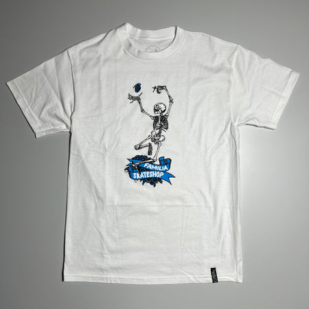 Full image of white tee with printed skeleton catching blue grenade. 
Familia Skateshop in blue ribbons