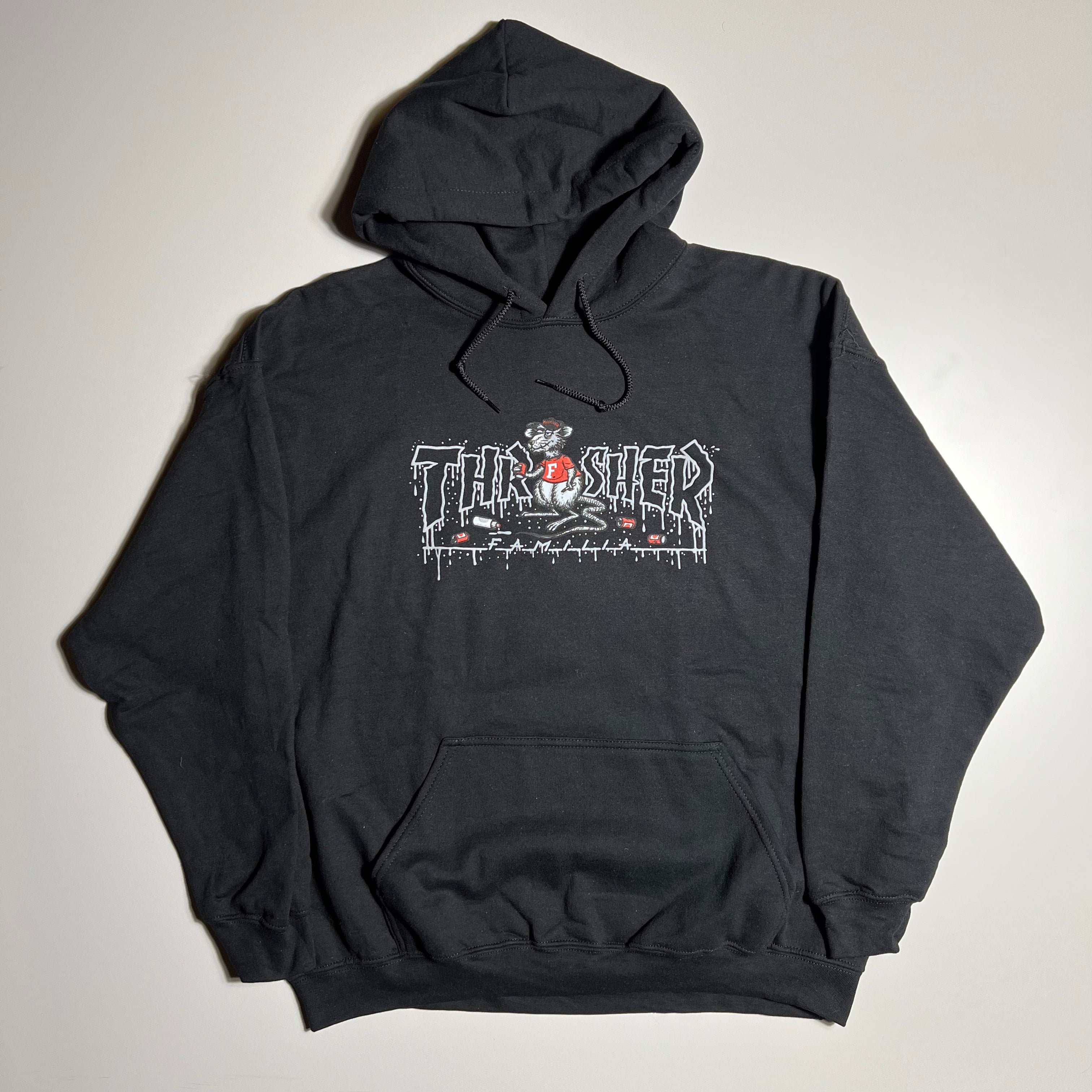 Full front image of black hoodie.
Thrasher logo with rat cartoon art printed on chest.