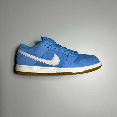 Side view of nike sb dunk in university blue, white leather swoosh logo and white and gum sole.