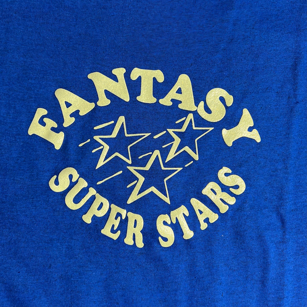 DETAILED SHOT OF BLUE TEE WITH FANTASY SUPER STARS LOGO CENTER CHEST
