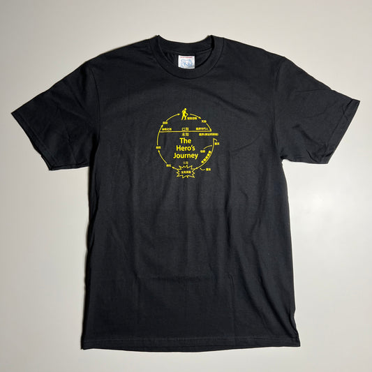 BLACK TEE WITH HERO'S JOURNEY GRAPHIC PRINTED IN YELLOW CENTER CHEST
