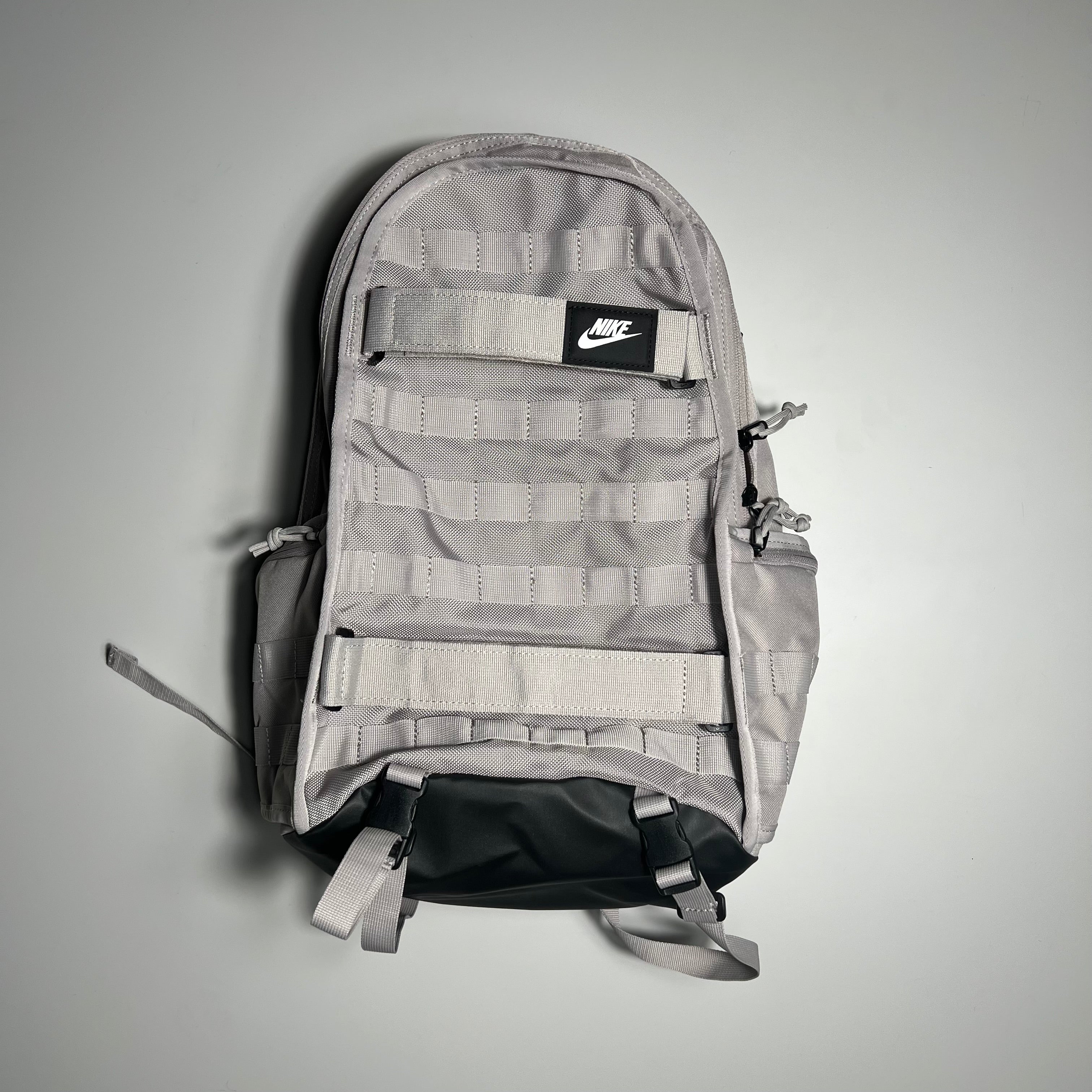 Gray backpack with a Nike logo on a gray background