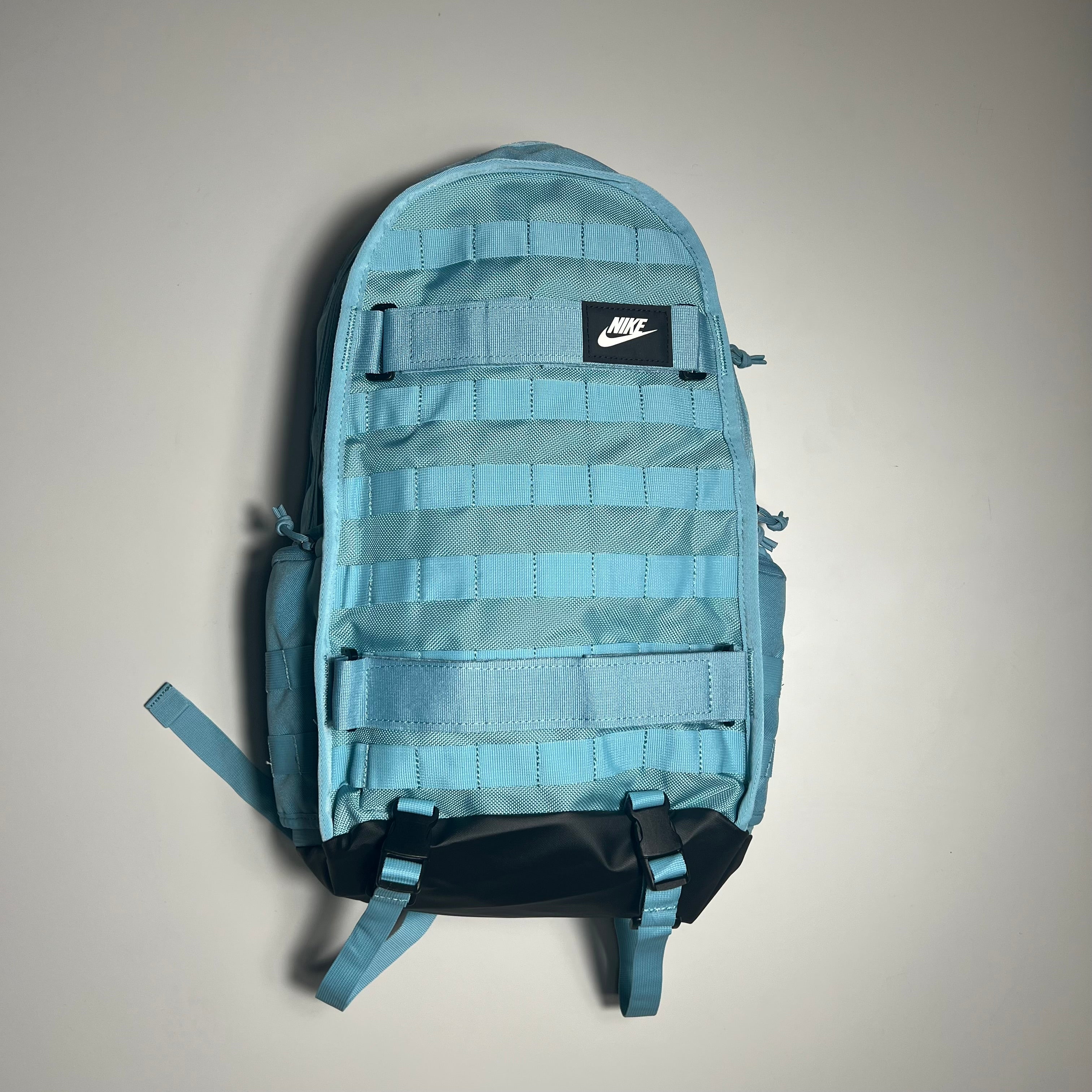 Light blue backpack with Nike logo on a gray background