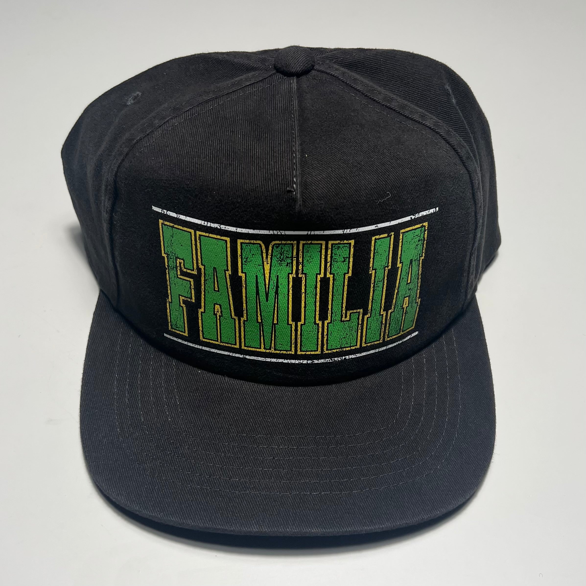 Black cap with green and white text on a light gray background