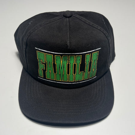 Black cap with green and white text on a light gray background
