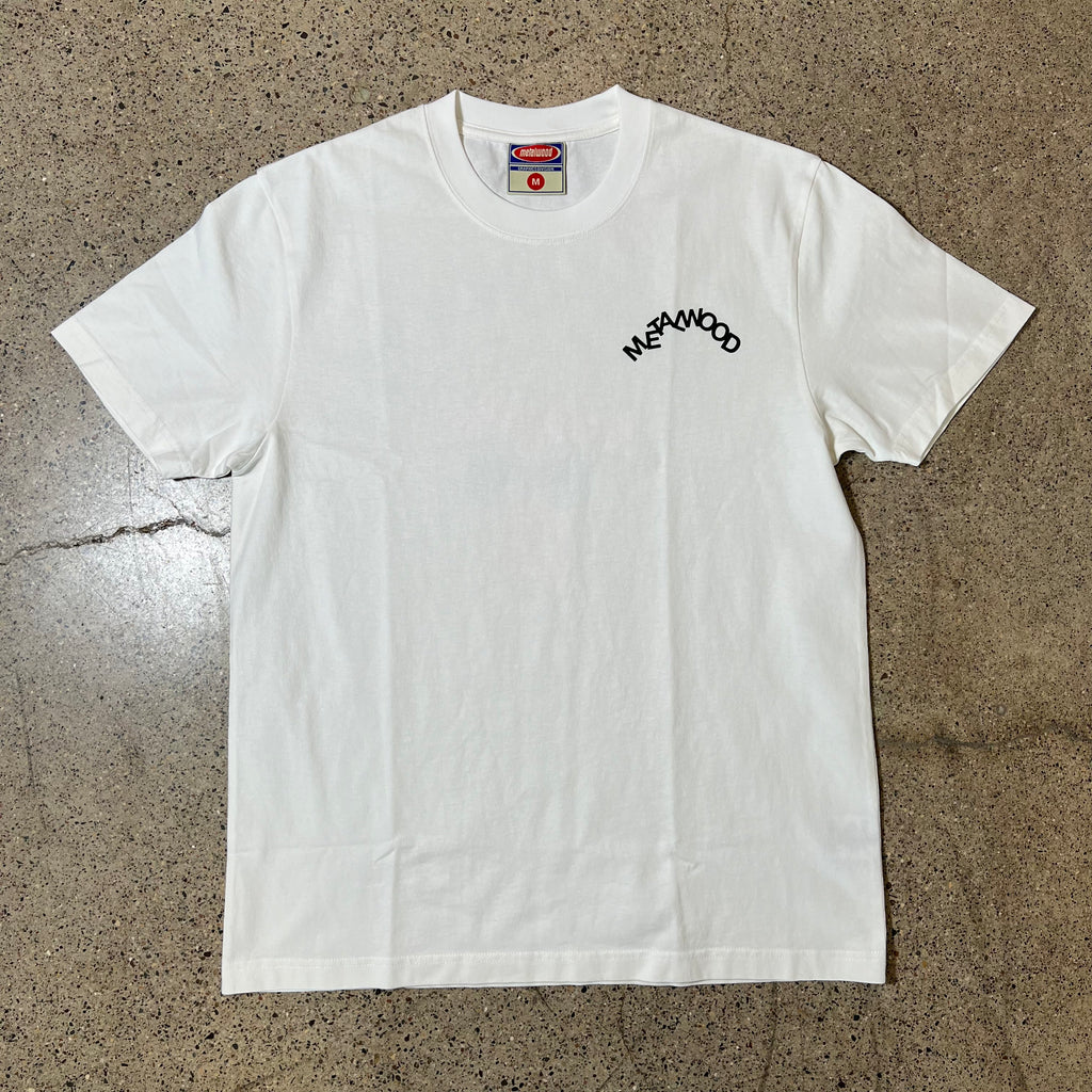 WHITE TEE WITH JUMBLED METALWOOD LOGO PRINTED ON LEFT SIDE CHEST