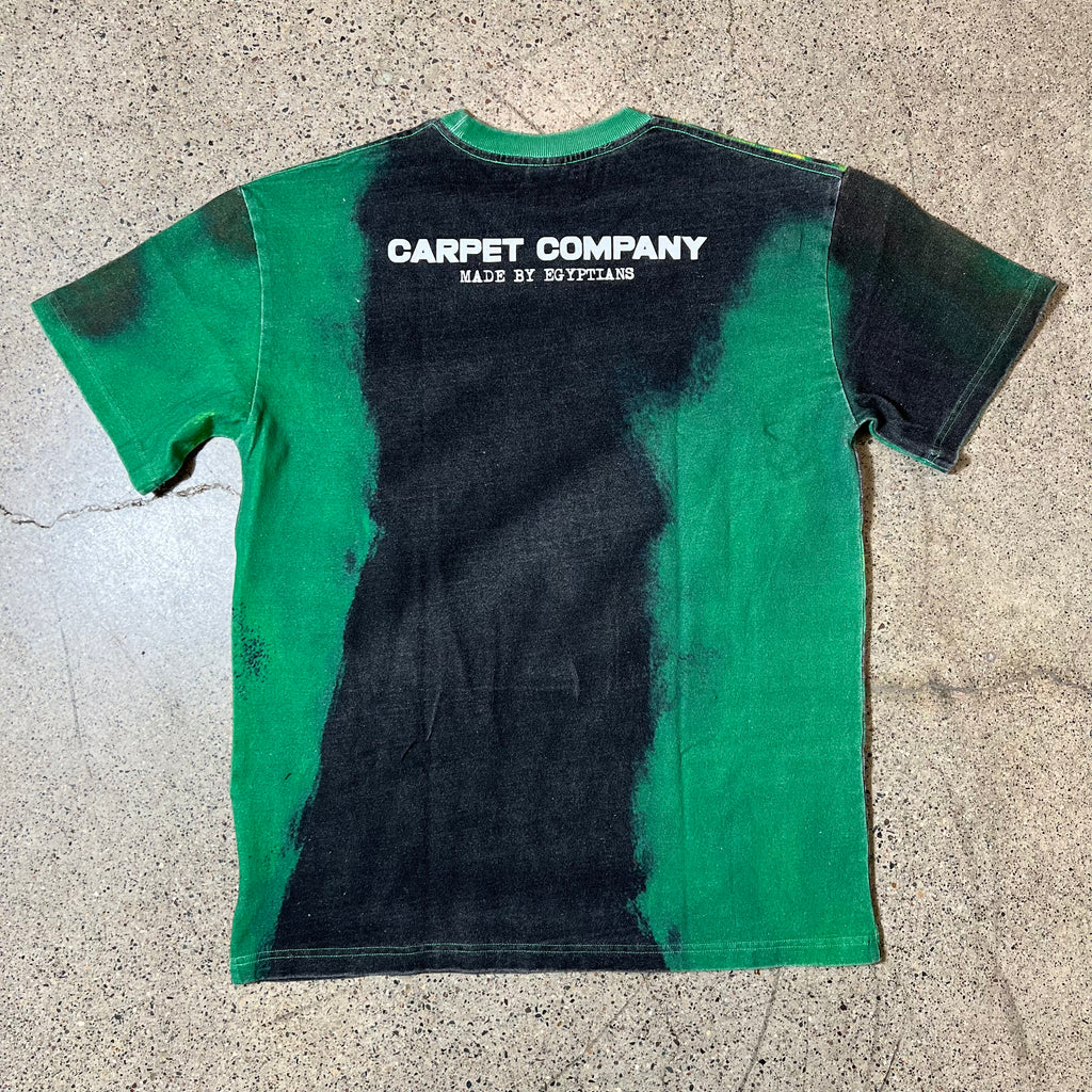 BACK SIDE OF CARPET EGYPT TEE IN BLACK GREEN AND YELLOW WITH FONT THAT READS CARPET COMPANY MADE BY EGYPTIANS