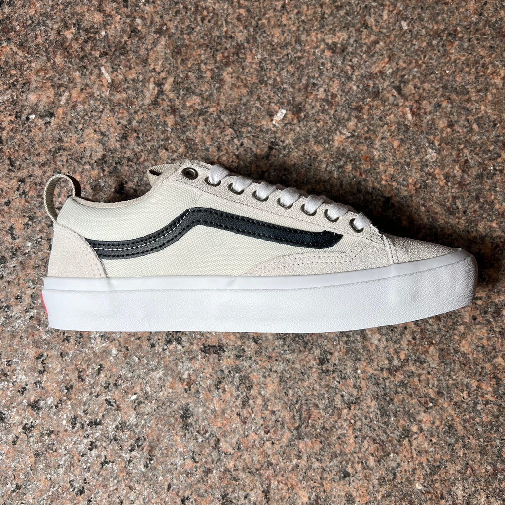 Side image of right shoe. White suede with nylon mid panel and black vans stripe.