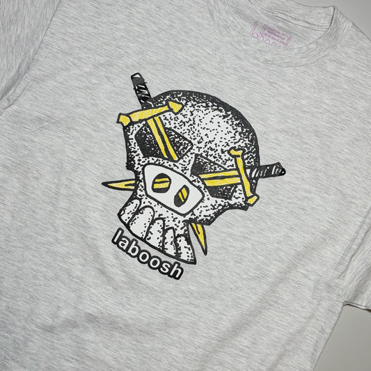 A close-up of a light heather gray t-shirt featuring a graphic of a skull with yellow swords in its eye sockets and the word 'laboosh' printed below.