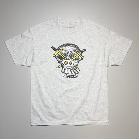 A light heather gray short-sleeve t-shirt featuring a graphic of a skull wearing a yellow bandana with crossed swords behind it and the word 'laboosh' printed below, laid flat on a neutral gray background.