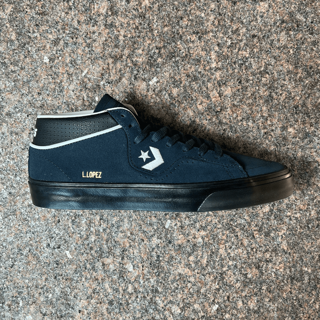 SINGLE CONVERSE CONS LOUIE LOPEZ PRO MODEL SHOE IN DARK BLUE AND BLACK SOLE DISPLAYED ON GRANITE